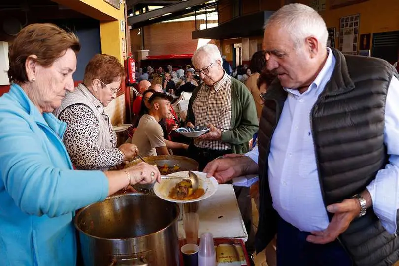 Algunos de los comensales, recogiendo la comida