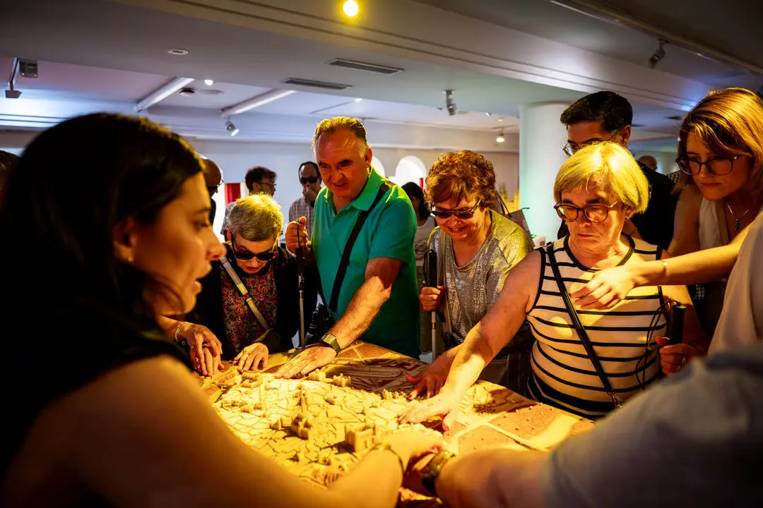 Personas con sordoceguera de Castilla-La Mancha tocan una de las maquetas del Museo Tiflol&oacute;gico de la ONCE