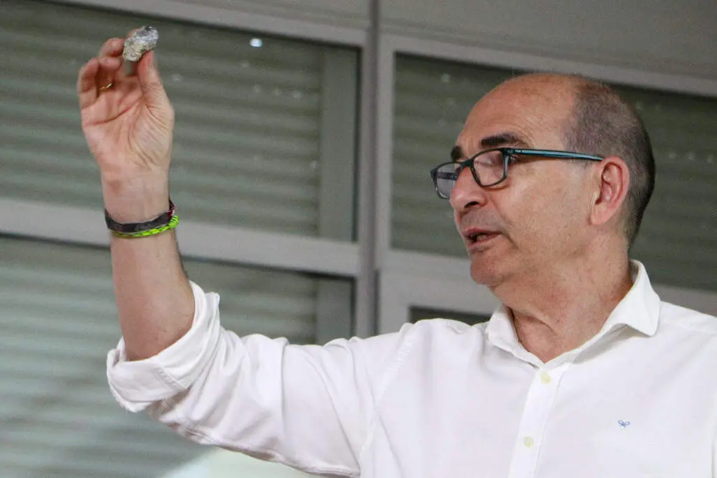 El ponente, mostrando una roca de galena argent&iacute;fera procedete de la explotaci&oacute;n de Minas del Horcajo